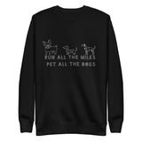 Image of the back of a black sweatshirt , pictures of three cute dogs, says "Run all the miles, pet all the dogs"