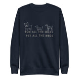 Image of the back of a dark blue sweatshirt , pictures of three cute dogs, says "Run all the miles, pet all the dogs"